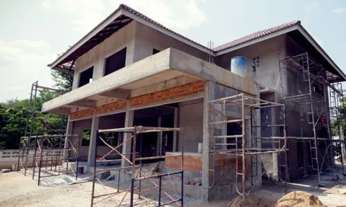 Building site with partially built house